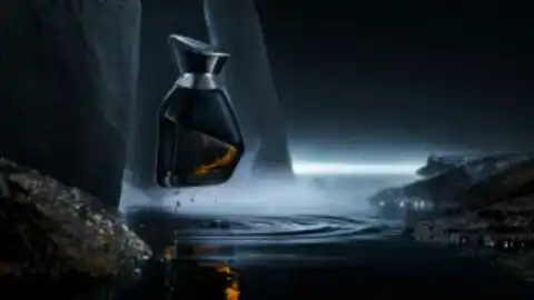 Creative preview of a sculptural black fragrance bottle suspended above a tidal pool.